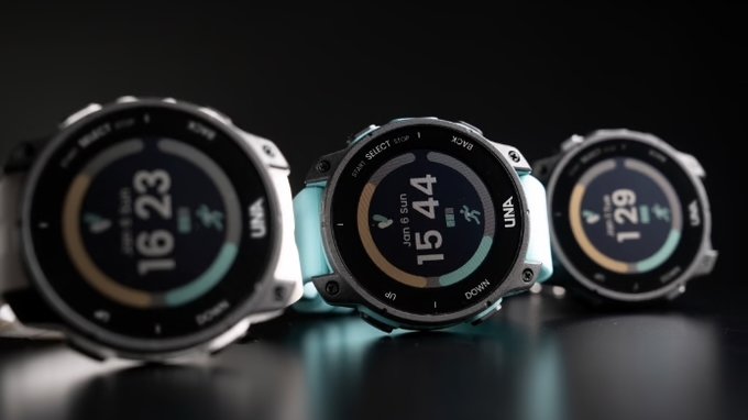 Three UNA Watch models with different strap colors in a row on a dark table, showing different data on each watch face.
