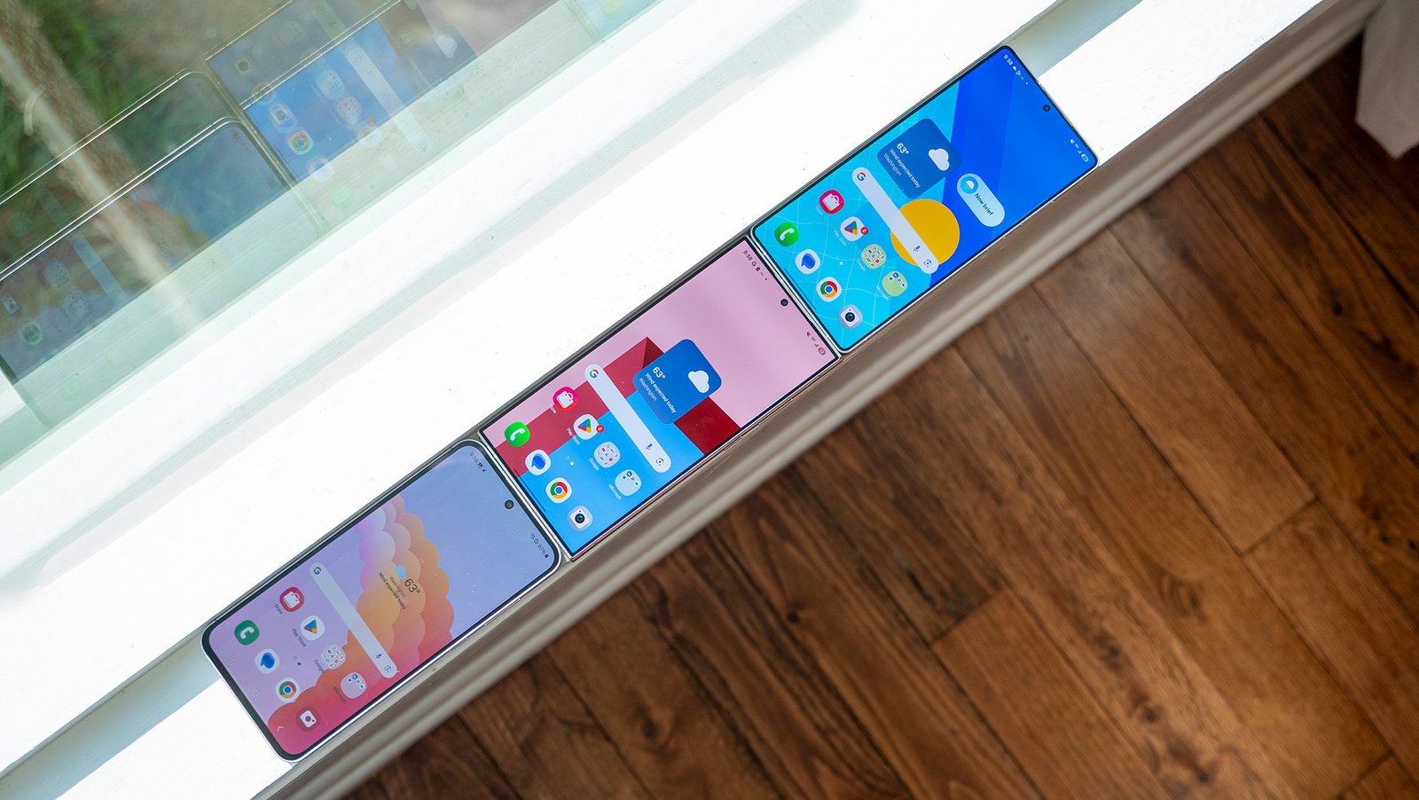 A Samsung Galaxy 24 FE, S24 Ultra, and S25 Ultra in the sun with High Brightness Mode enabled