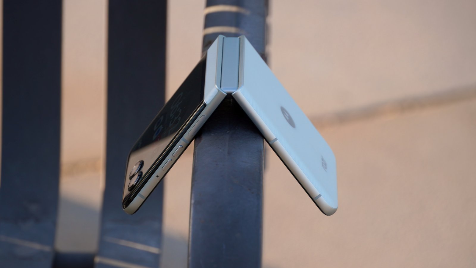 A side view of the Motorola Razr 2025 hanging off a park bench.