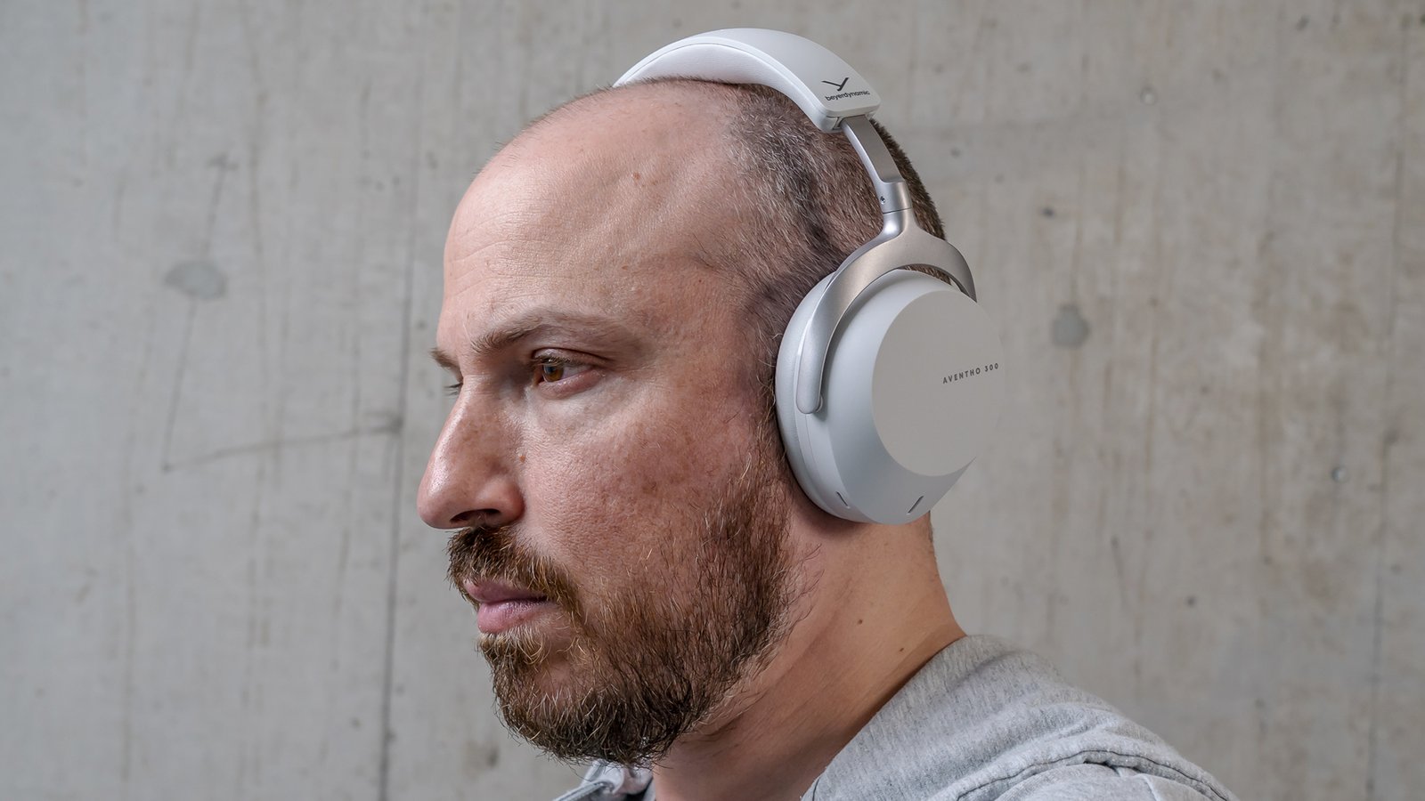 Side view of a person wearing Beyerdynamic Aventho 300 headphones.