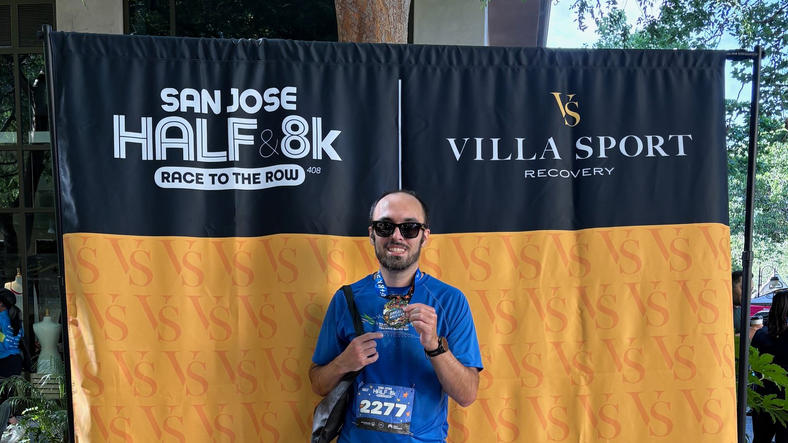 The author wearing Meta Ray-Ban smart glasses and a finisher medal at the San Jose Half Marathon.