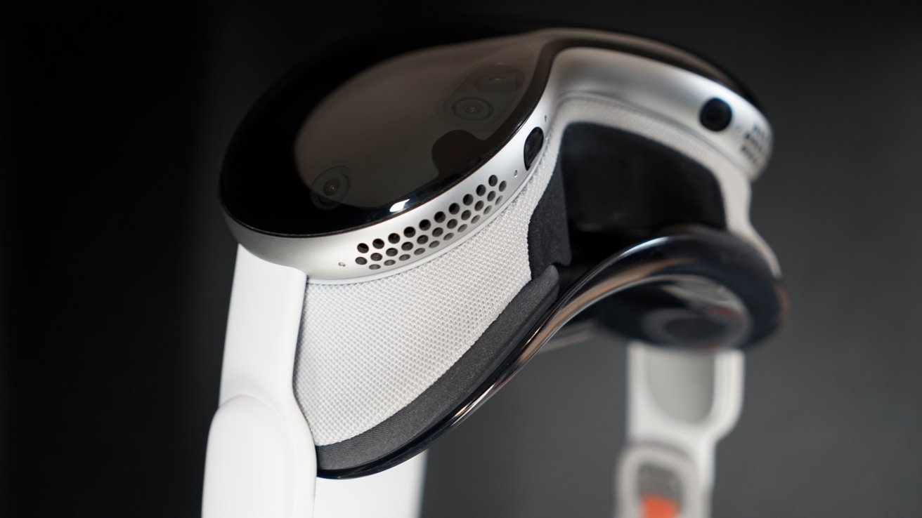 Sleek virtual reality headset with a glossy exterior, featuring numerous small cameras and mesh padding for comfort.