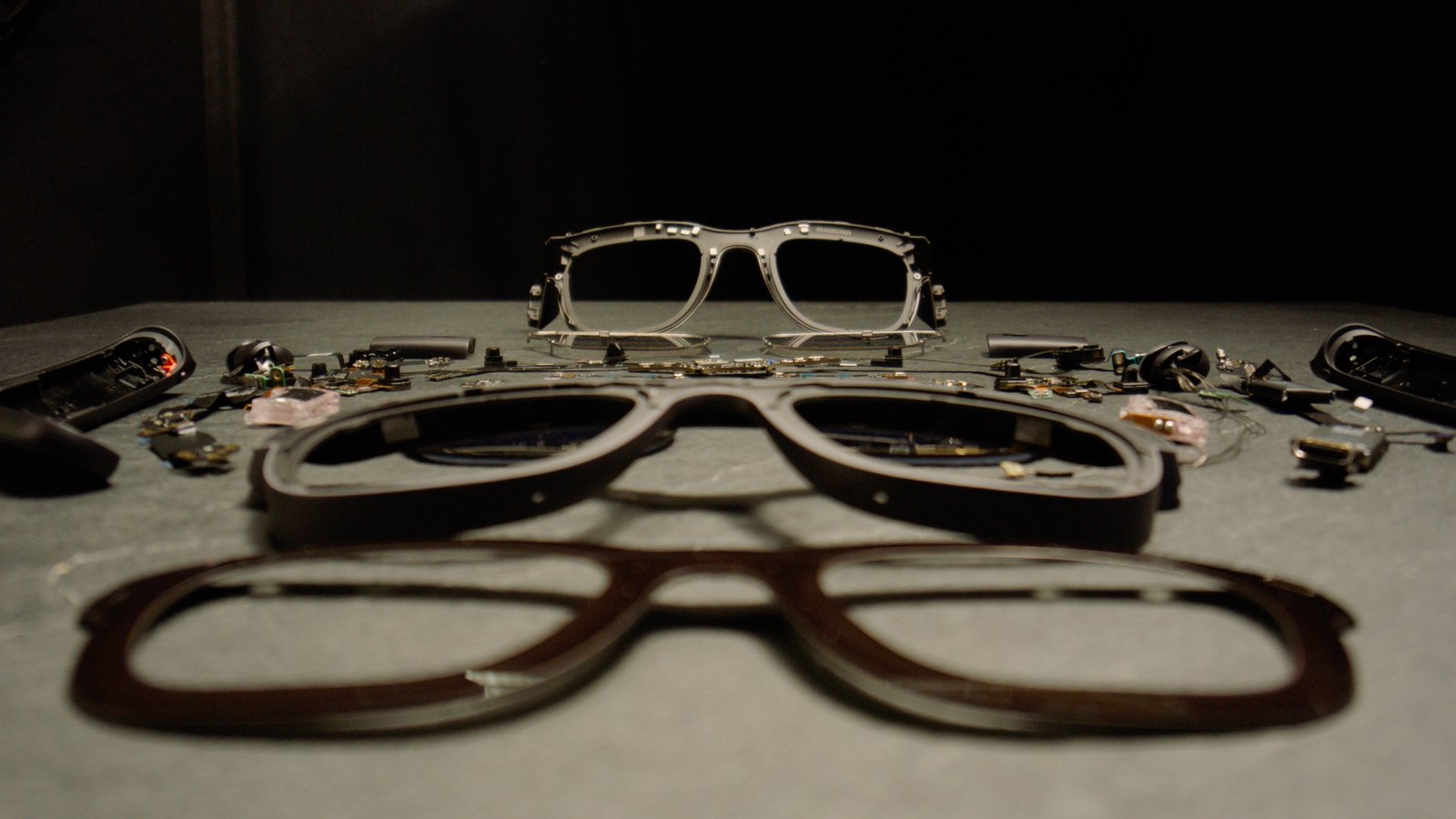 The Meta Orion AR glasses disassembled and sitting on a gray table