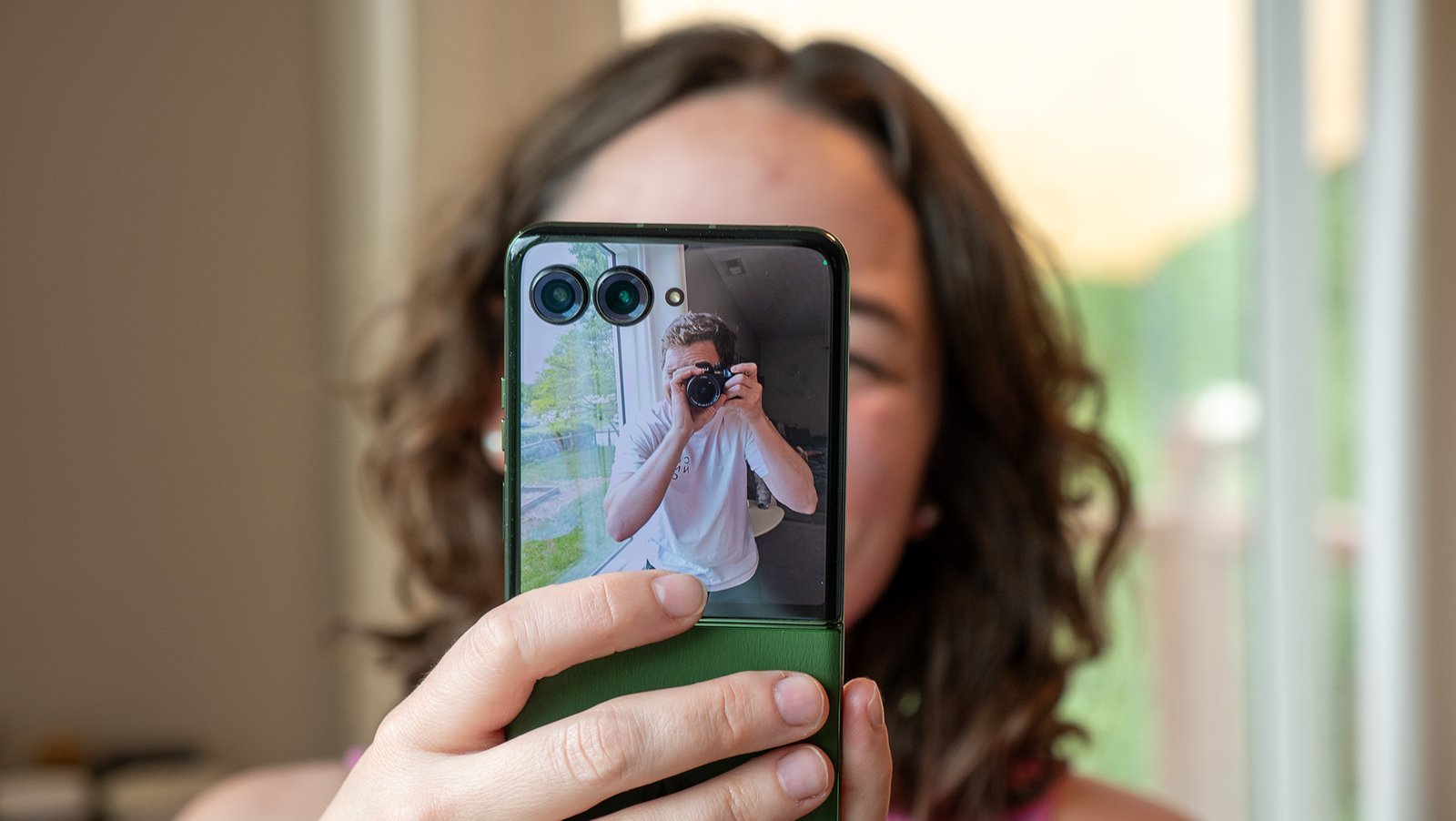 Taking a picture of me taking a picture of the Motorola Razr Plus 2024 with its cover screen camera viewfinder active