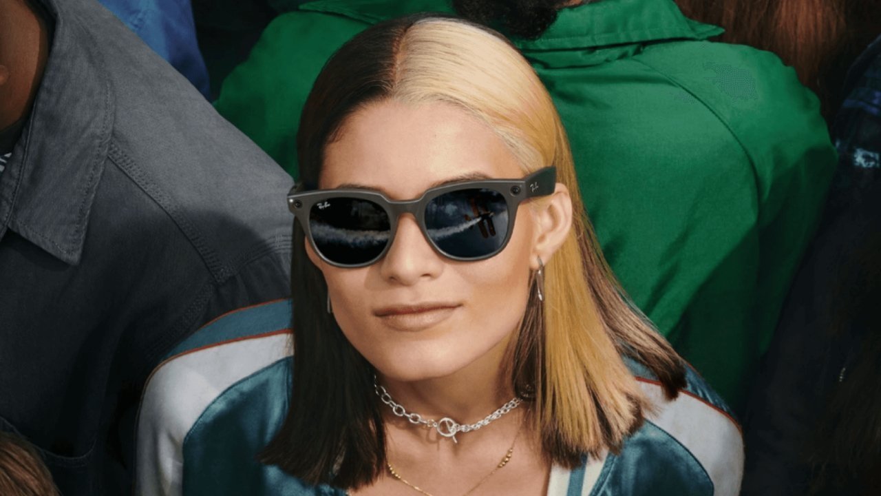 A person wearing sunglasses reflecting an outdoor scene.