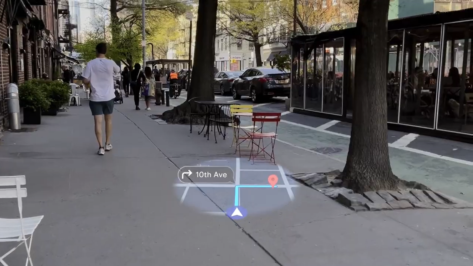 A still from an Android XR example video demonstrating navigation with Google Maps, featuring a holographic view of the map showing directions.